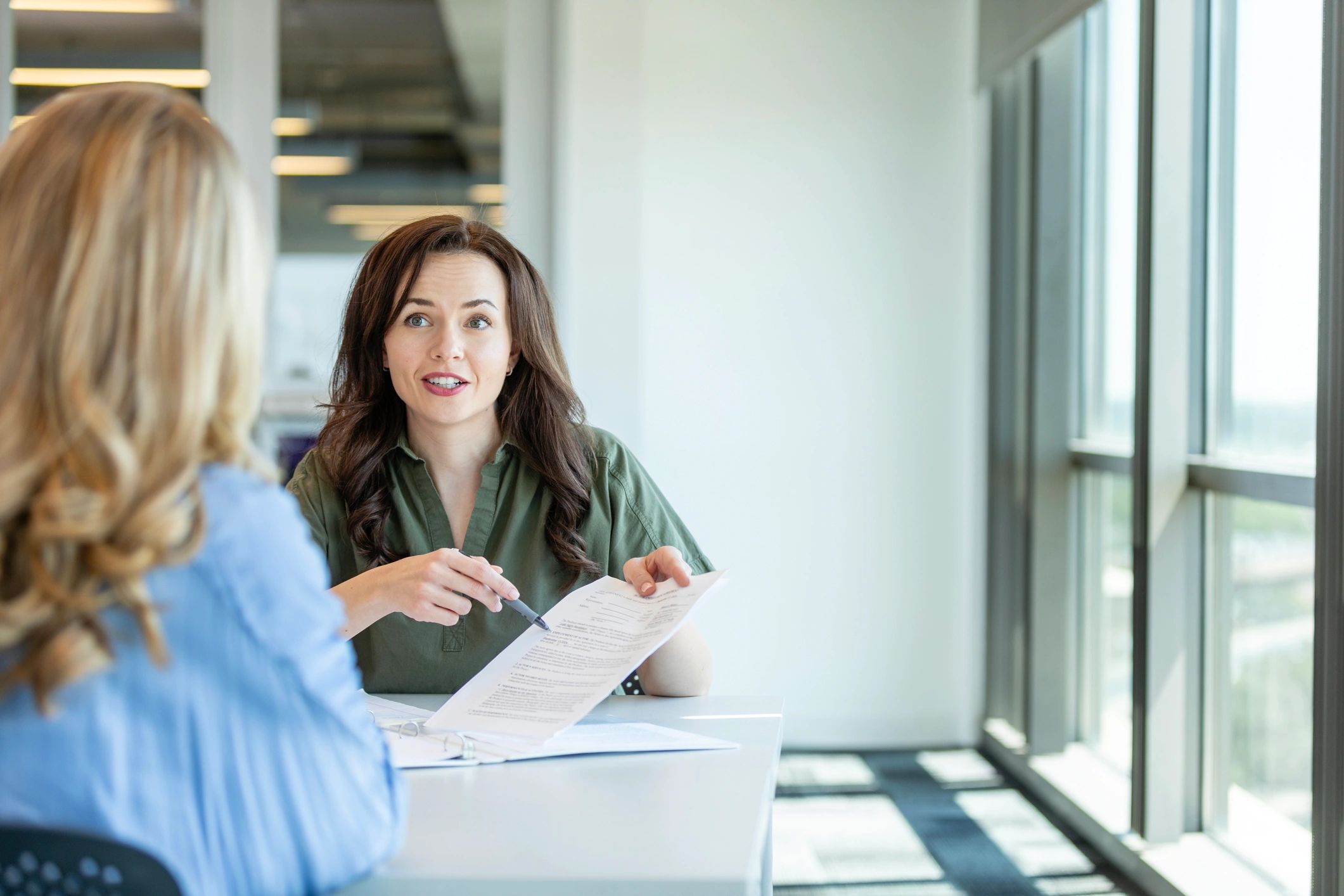 Legal advisor reviewing documents with a client