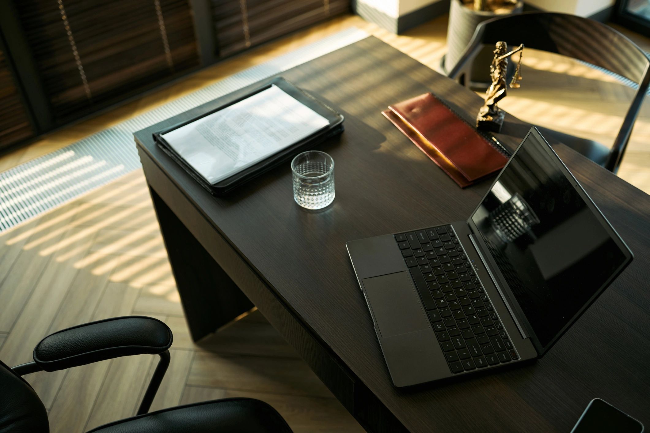 Law office desk with legal documents and laptop